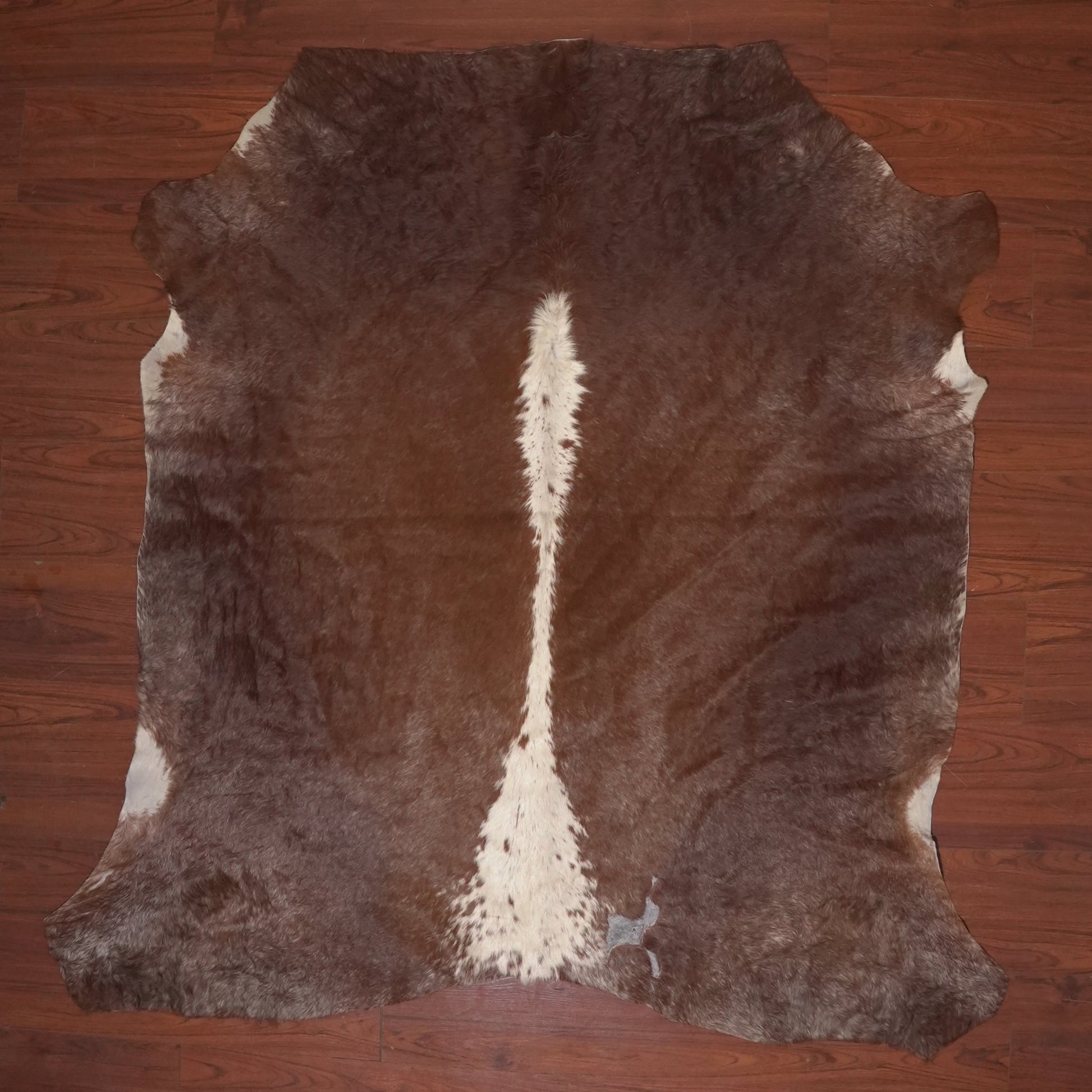 cow hide rug on wood floor