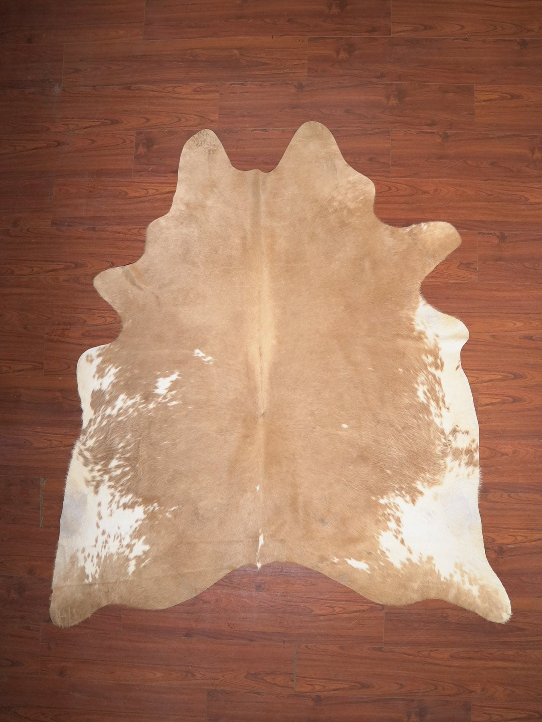cow hide rug on wood floor