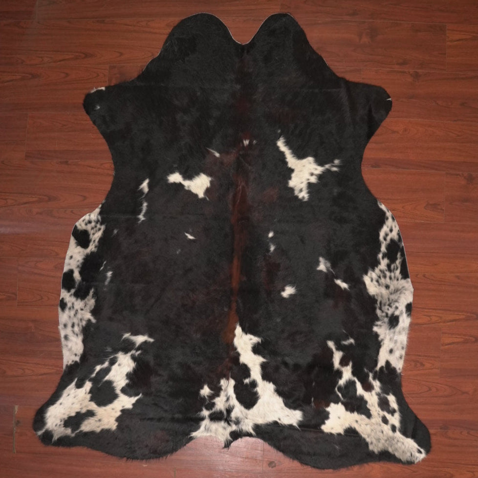 cow hide rug on wood floor