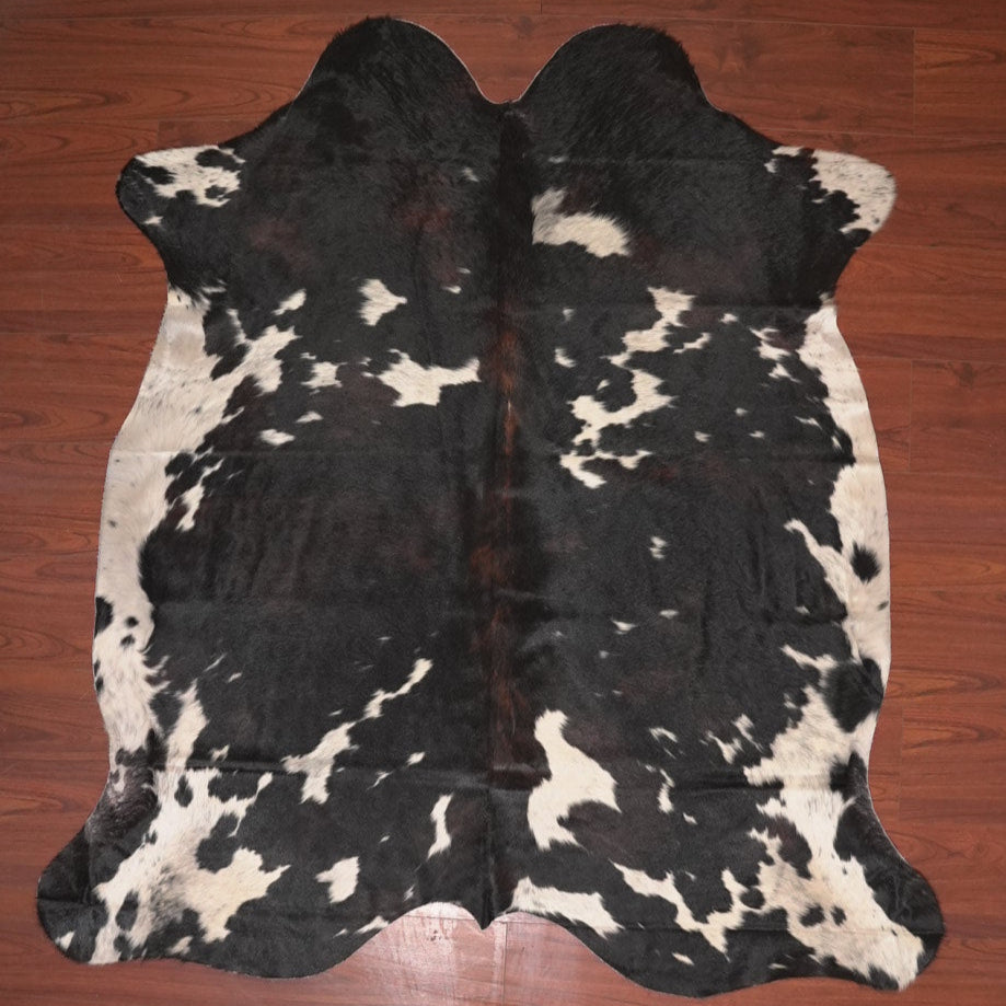 cow hide rug on wood floor
