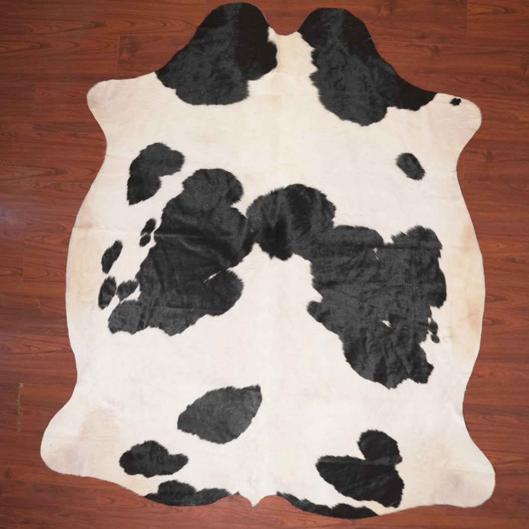 cow hide rug on wood floor