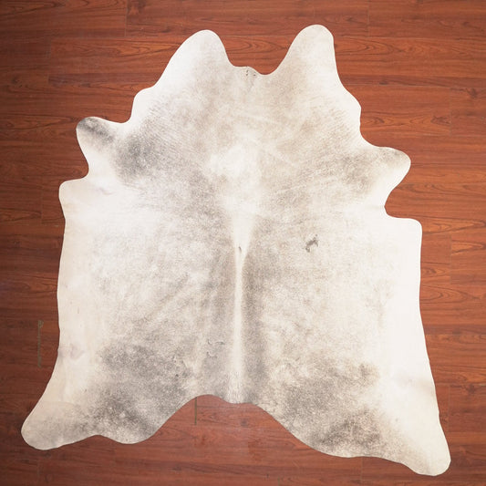 cow hide rug on wood floor