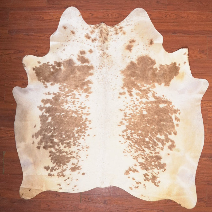 cow hide rug on wood floor