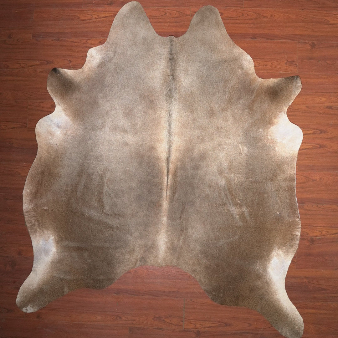 cow hide rug on wood floor