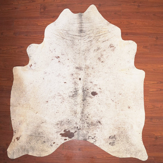 Cowhide rug on a wooden floor