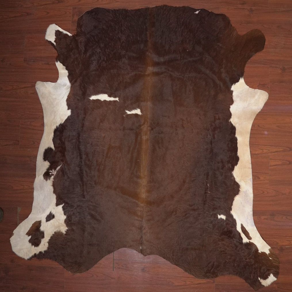 cow hide rug on wood floor