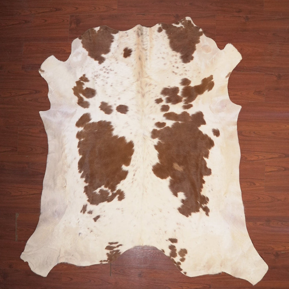 cow hide rug on wood floor