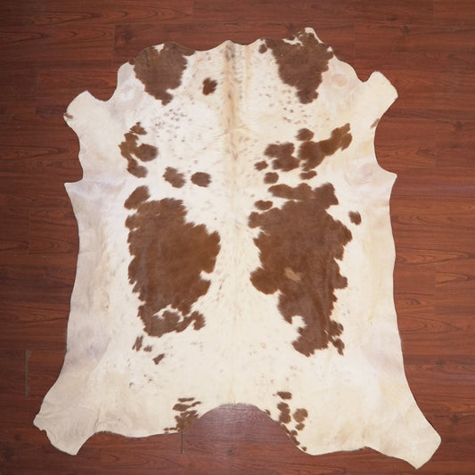 cow hide rug on wood floor