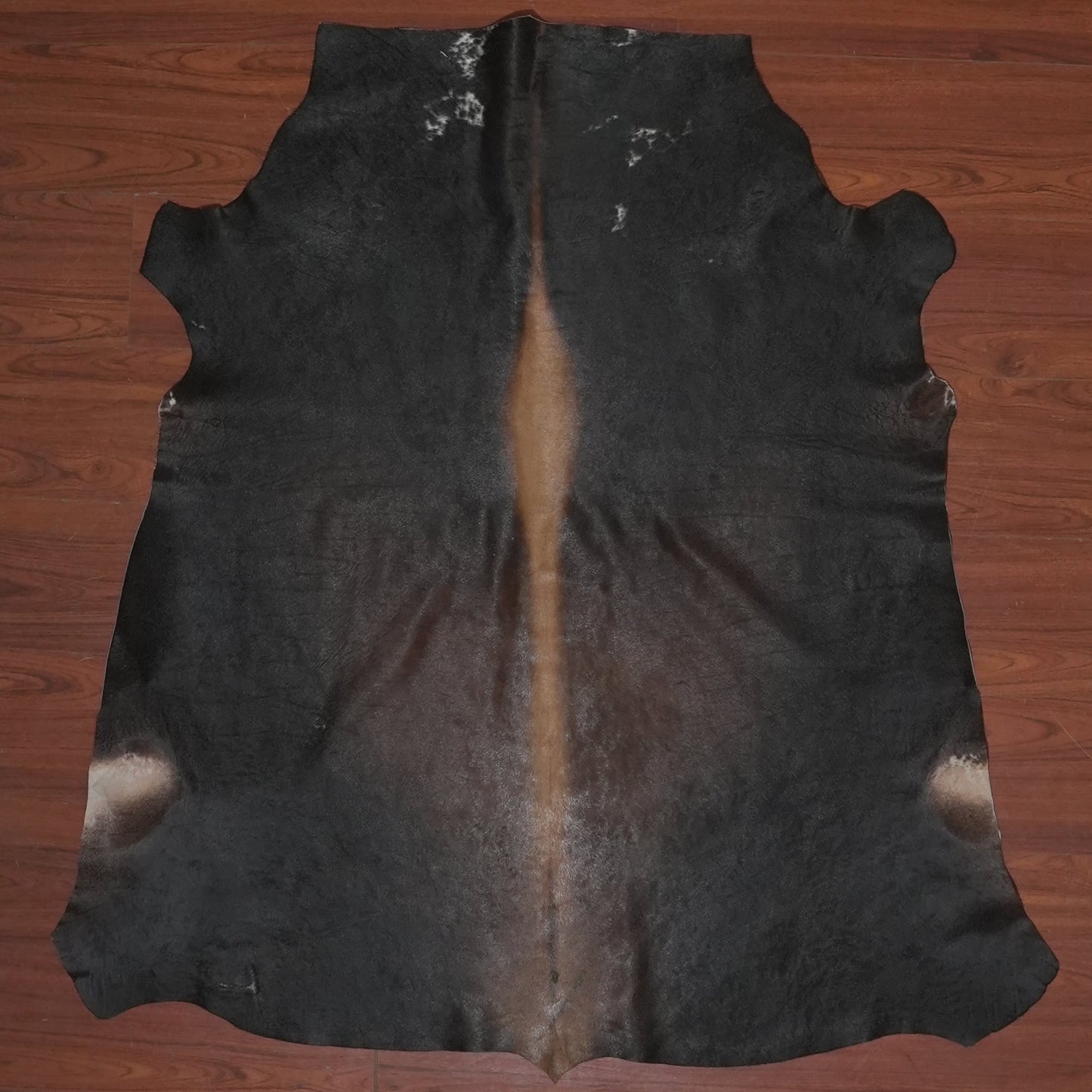 Cowhide rug on a wooden floor