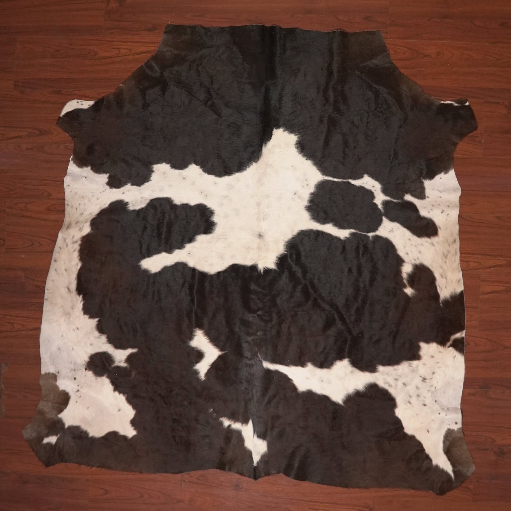 cow hide rug on wood floor