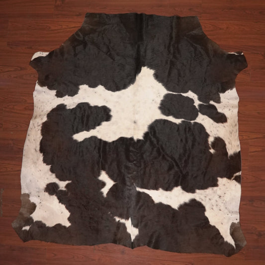 cow hide rug on wood floor