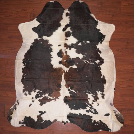 cow hide rug on wood floor