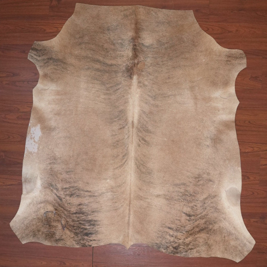 cow hide rug on wood floor