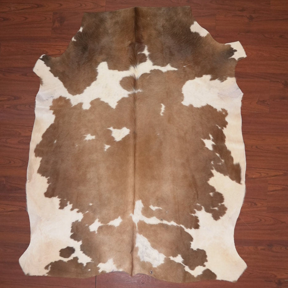 cow hide rug on wood floor