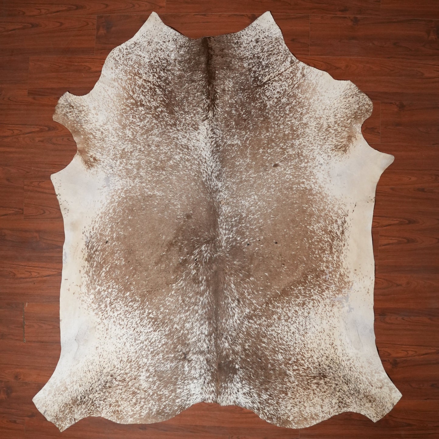 Cowhide rug on a wooden floor
