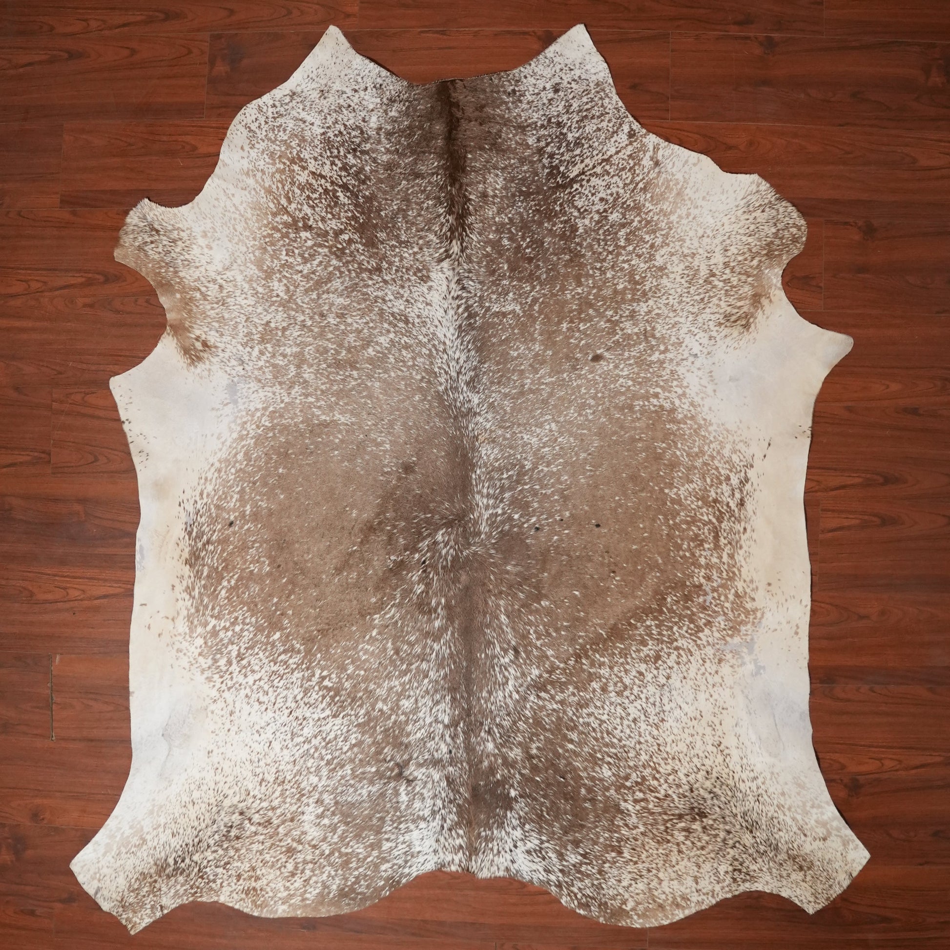 Cowhide rug on a wooden floor
