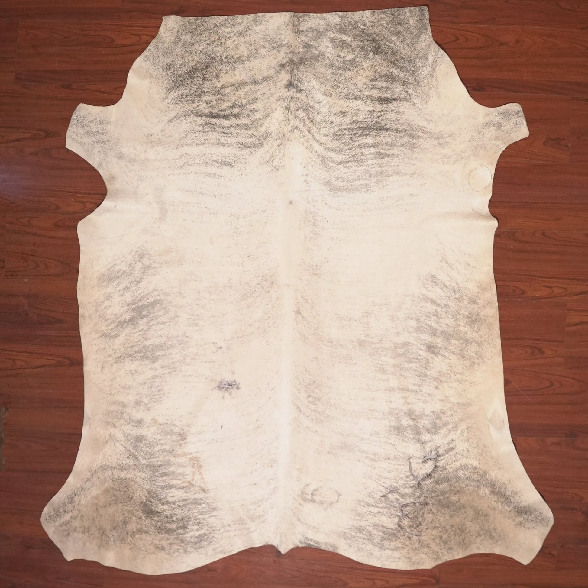 cow hide rug on wood floor