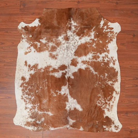 Cowhide rug on a wooden floor