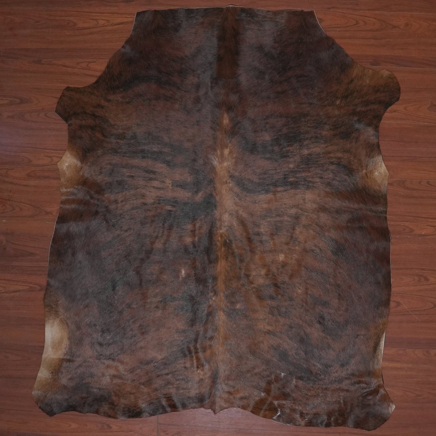 cow hide rug on wood floor