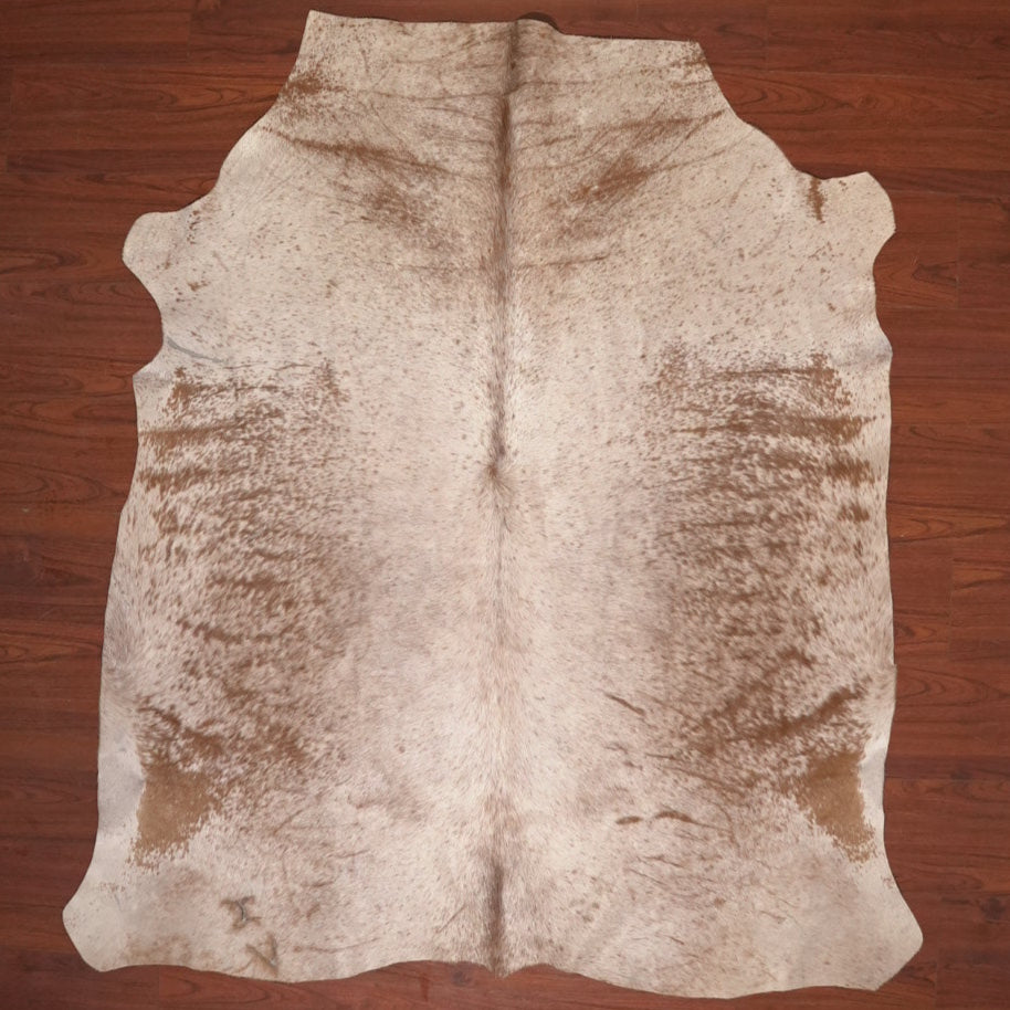 Cowhide rug on a wooden floor