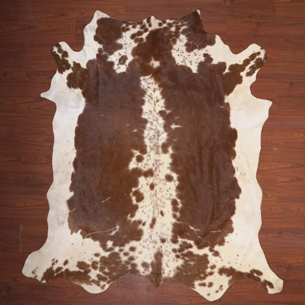 cow hide rug on wood floor