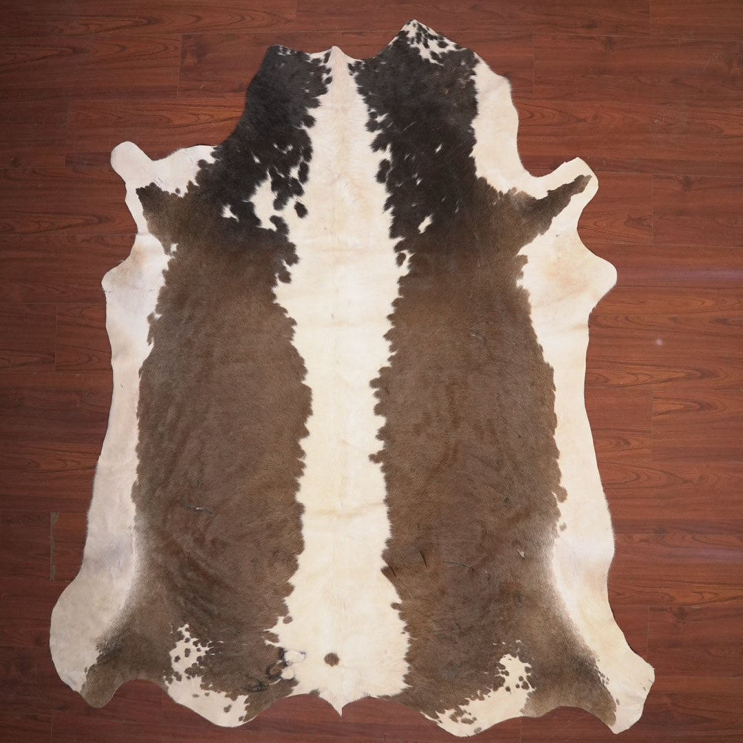 cow hide rug on wood floor