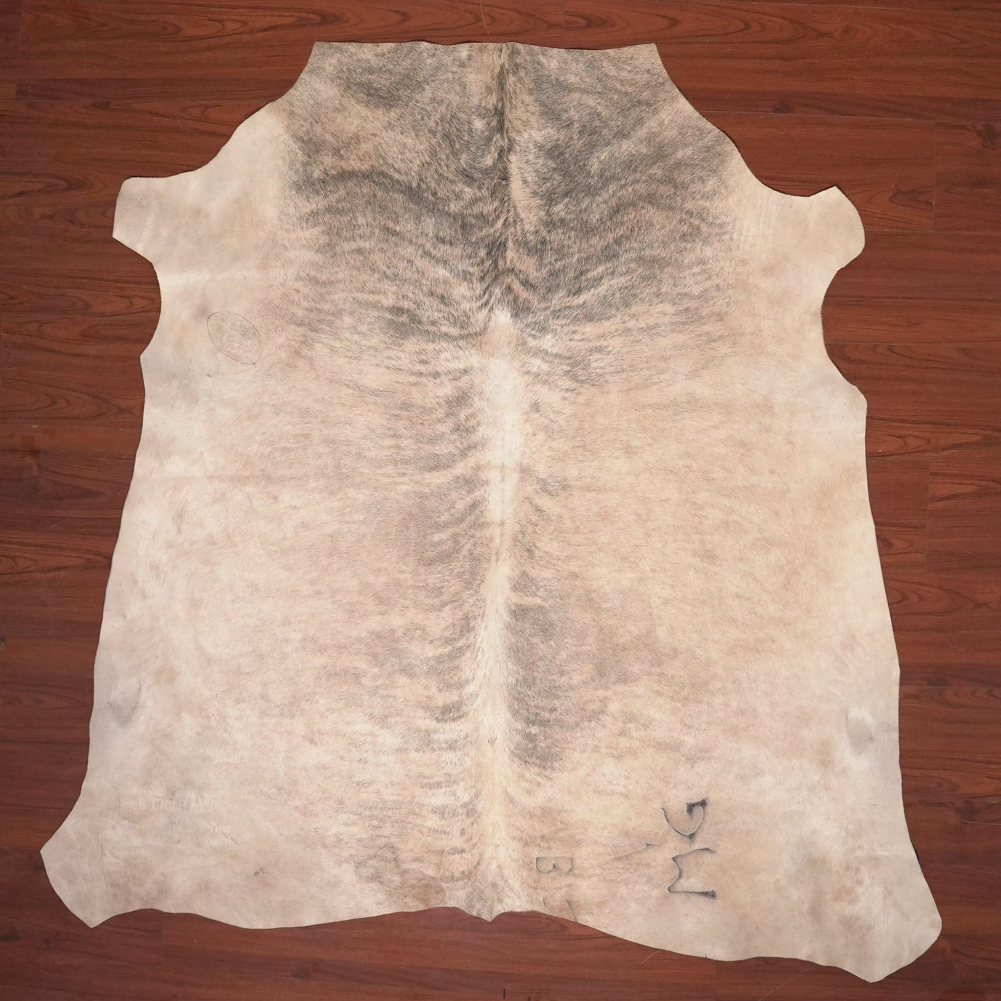 cow hide rug on wood floor