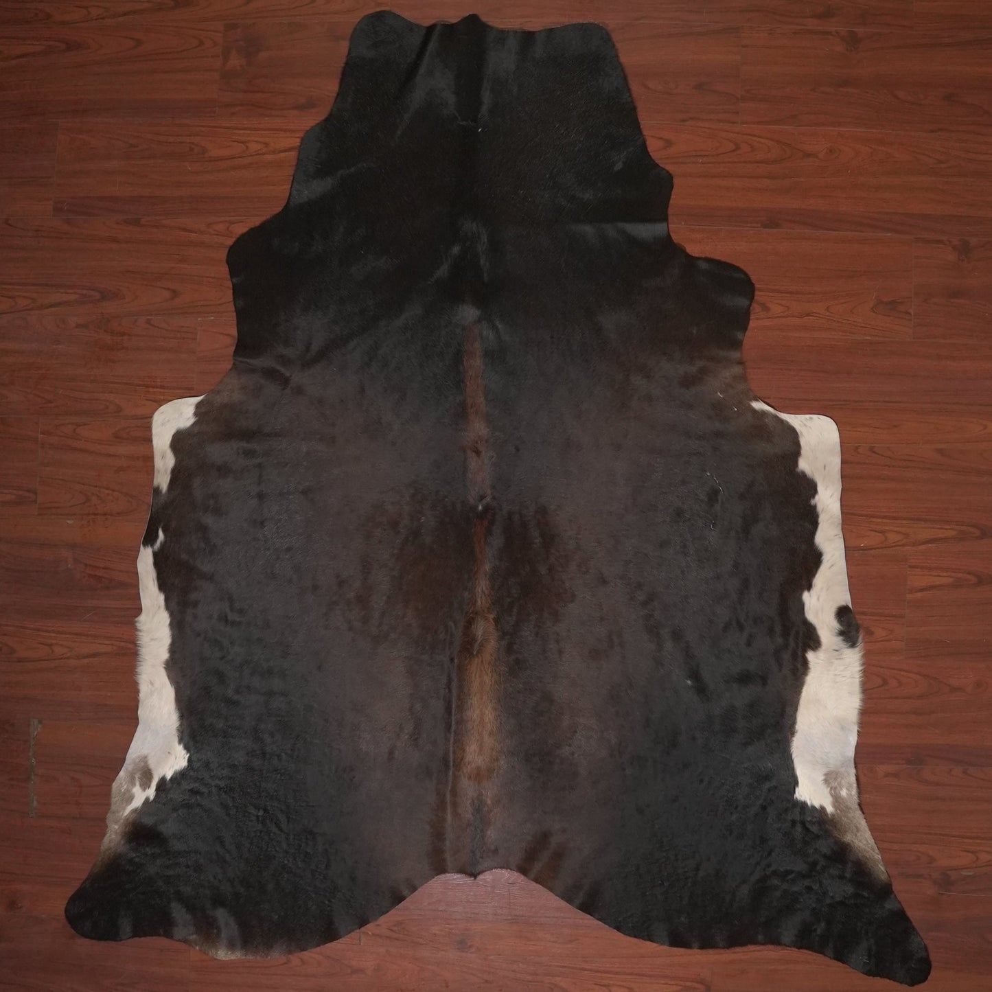 cow hide rug on wood floor