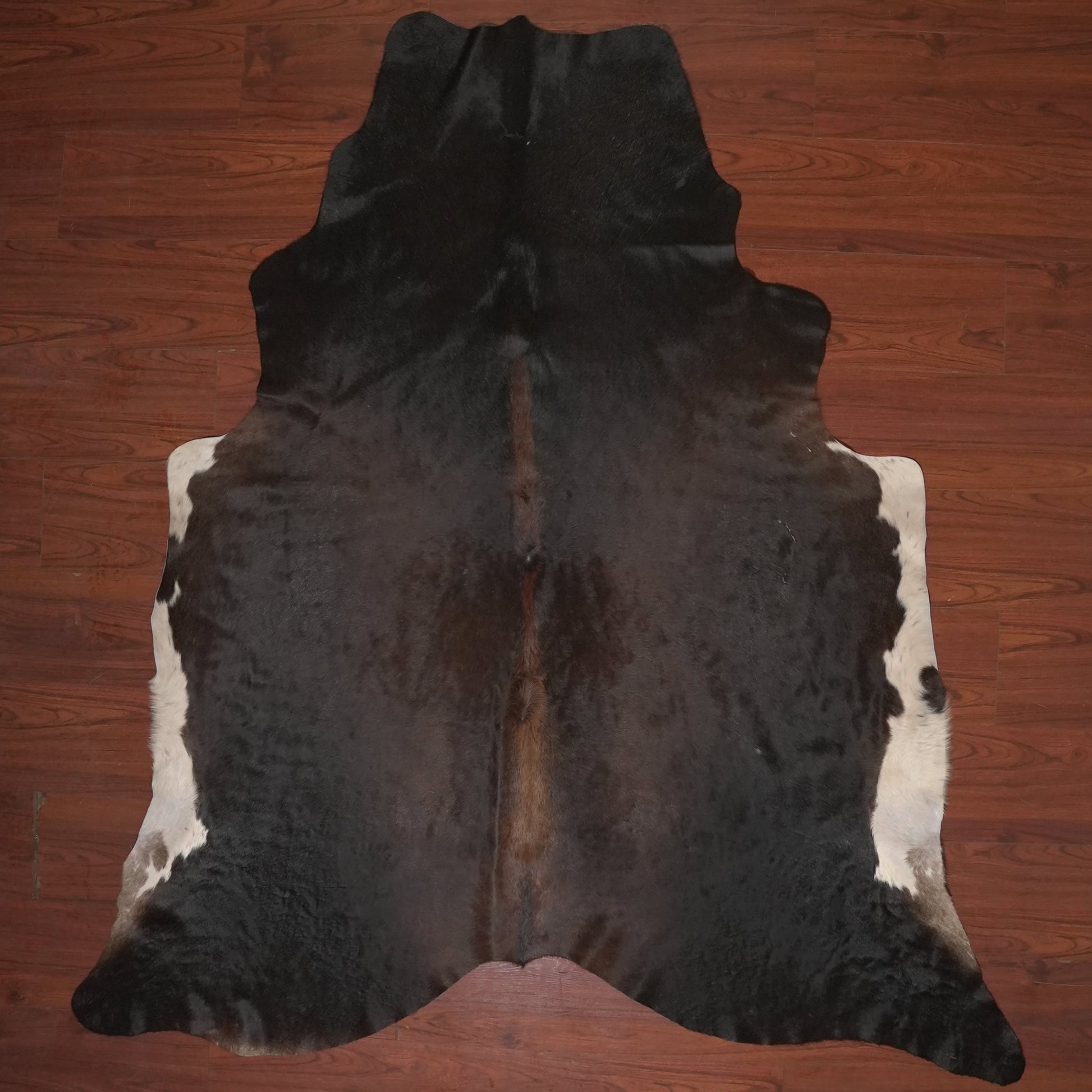 cow hide rug on wood floor