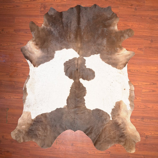 Cowhide rug on a wooden floor
