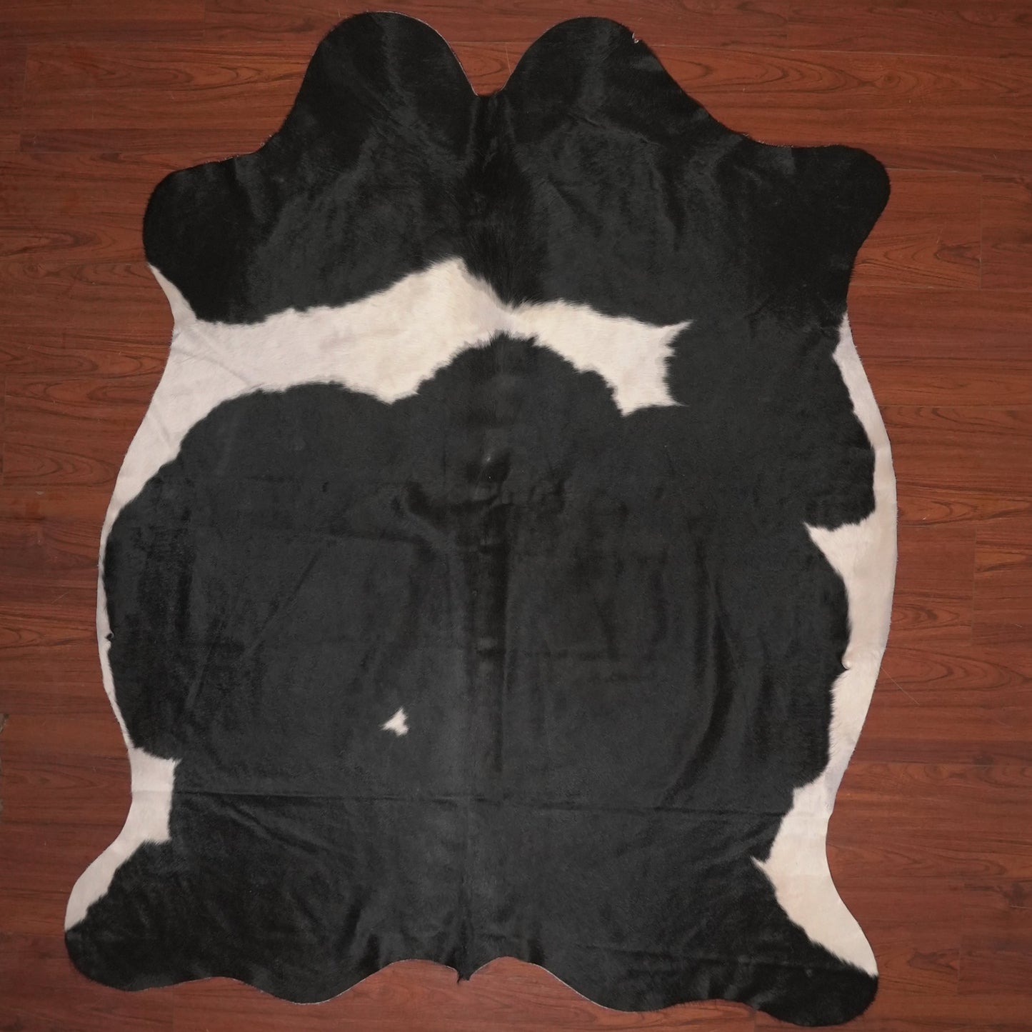 cow hide rug on wood floor