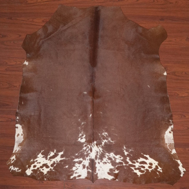 cow hide rug on wood floor