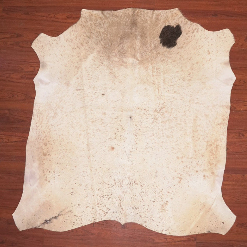 cow hide rug on wood floor